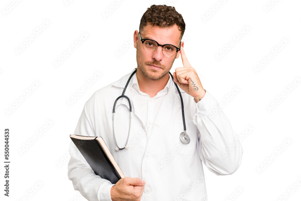 Young doctor caucasian man holding a book isolated pointing temple with finger, thinking, focused on a task. Young doctor caucasian man holding a book isolated pointing temple with finger, thinking, focused on a task.