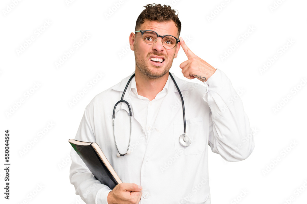 Young doctor caucasian man holding a book isolated showing a disappointment gesture with forefinger. Young doctor caucasian man holding a book isolated showing a disappointment gesture with forefinger.