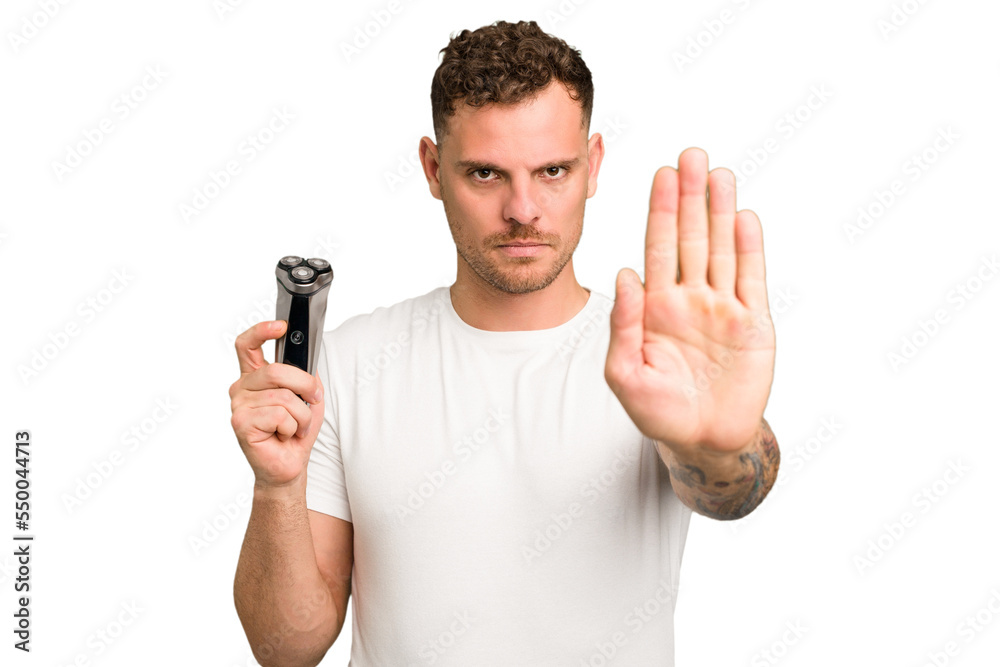 Young caucasian man holding a razor isolated standing with outstretched hand showing stop sign, preventing you. Young caucasian man holding a razor isolated standing with outstretched hand showing stop sign, preventing you.