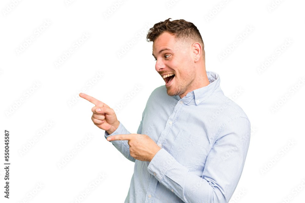 Young caucasian handsome man isolated points with thumb finger away, laughing and carefree. Young caucasian handsome man isolated points with thumb finger away, laughing and carefree.