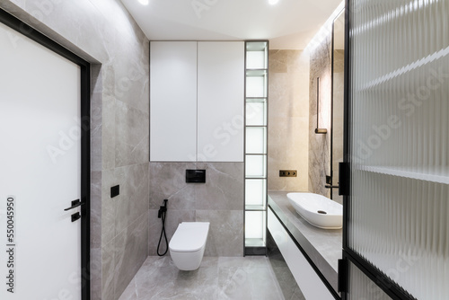 modern bathroom interior design with lighting and gray tiles