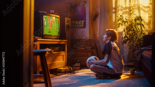 Young Sports Fan Watches a Soccer Match on Retro TV in His Room with Dated Interior. Boy Supporting His Favorite Football Team, Proud When Players Score a Goal. Nostalgic Childhood Concept.