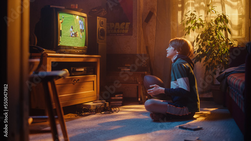 Young Sports Fan Watches American Football Match on Retro TV in His Vintage Room with Dated Interior. Boy Supporting His Favorite Team, Feeling Proud When Players Score a Goal. Nostalgic Childhood.
