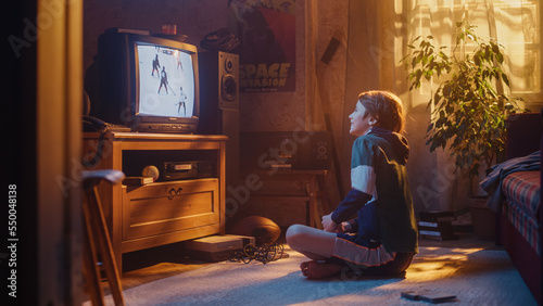 Nostalgic Retro Childhood Concept. Young Boy Watches Hockey Match on TV in His Room with Dated Interior. Supporting His Favorite Team  Getting Excited When Players Score a Goal.