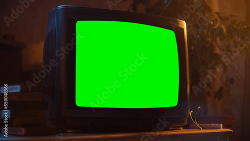 Obraz na plátně Close Up Footage of a Dated TV Set with Green Screen Mock Up Chroma Key Template Display