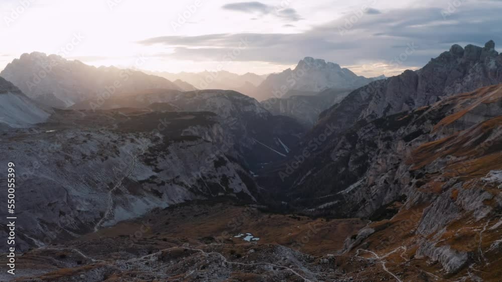 Aerial view of rocks at colorful sunset in autumn in Tre Cime, Dolomites, Italy. Colorful landscape. Top view from drone of mountains, sky with clouds, golden sunlight in fall. View from above. Nature Aerial view of rocks at colorful sunset in autumn in Tre Cime, Dolomites, Italy. Colorful landscape. Top view from drone of mountains, sky with clouds, golden sunlight in fall. View from above. Nature