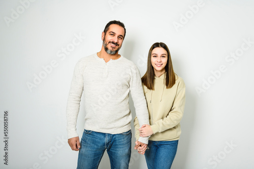 father and cute teen isolated on white on studio