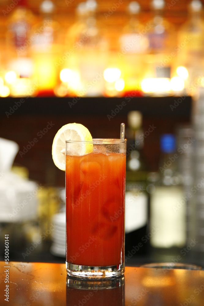 Red cocktail with lemon slice and glass stirrer Red cocktail with lemon slice and glass stirrer