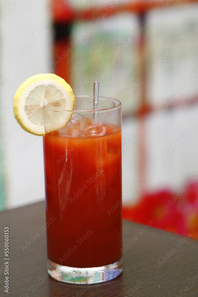 Red cocktail with lemon slice and glass stirrer Red cocktail with lemon slice and glass stirrer