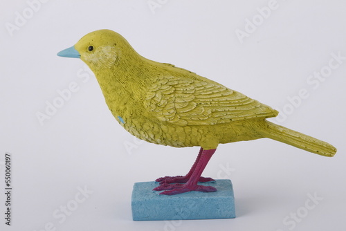 Fotografie Painted ceramic bird ornamental paperweight against a white background