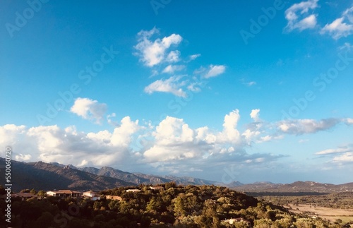 Corsica horizon with mountains and treeline with blue sky and beautiful clouds