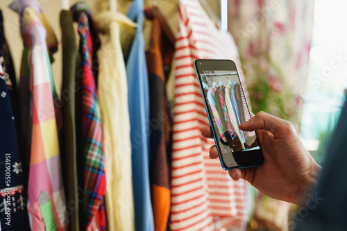 Konstfotografi Taking photos of pre owned clothes hanging on rail for resale or clothing rental