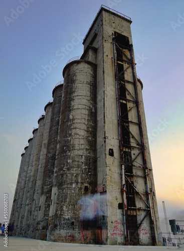 Vertical low angle shot of an old factory building in Drapetsona, Lipasmata, Greece. photo