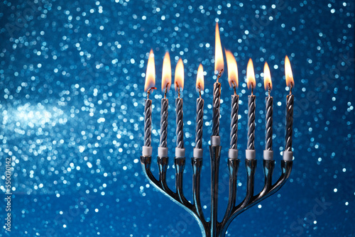 Jewish holiday Hanukkah background with menorah -traditional candelabra and candles