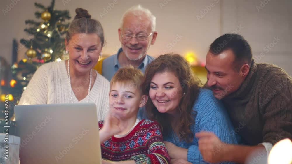 Big family wave hands during online video call celebrating Christmas with relatives. Realtime. Big family wave hands during online video call celebrating Christmas with relatives. Realtime.