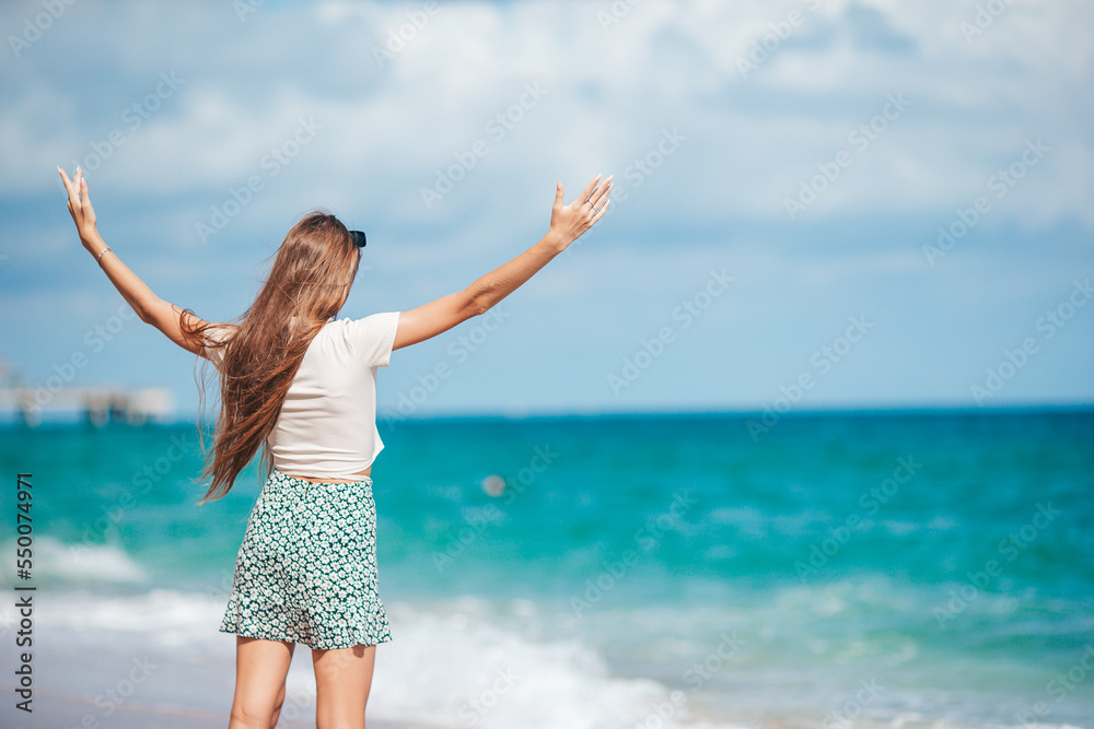 Happy young girl enjoy tropical beach vacation Happy young girl enjoy tropical beach vacation
