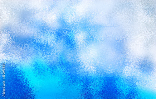 Frosted blue glass texture. Colorful lights background.