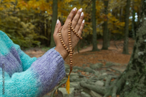 female hands holding the buddhist mala
