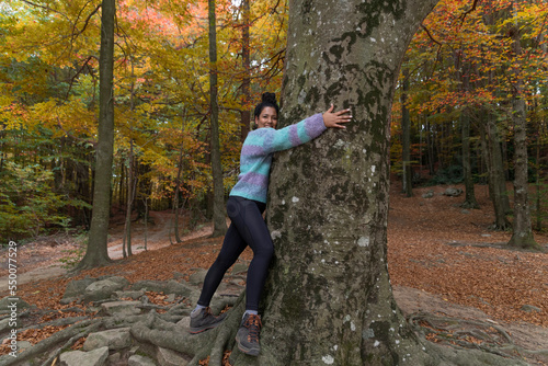 happy young woman
nature lover hugging a tree
