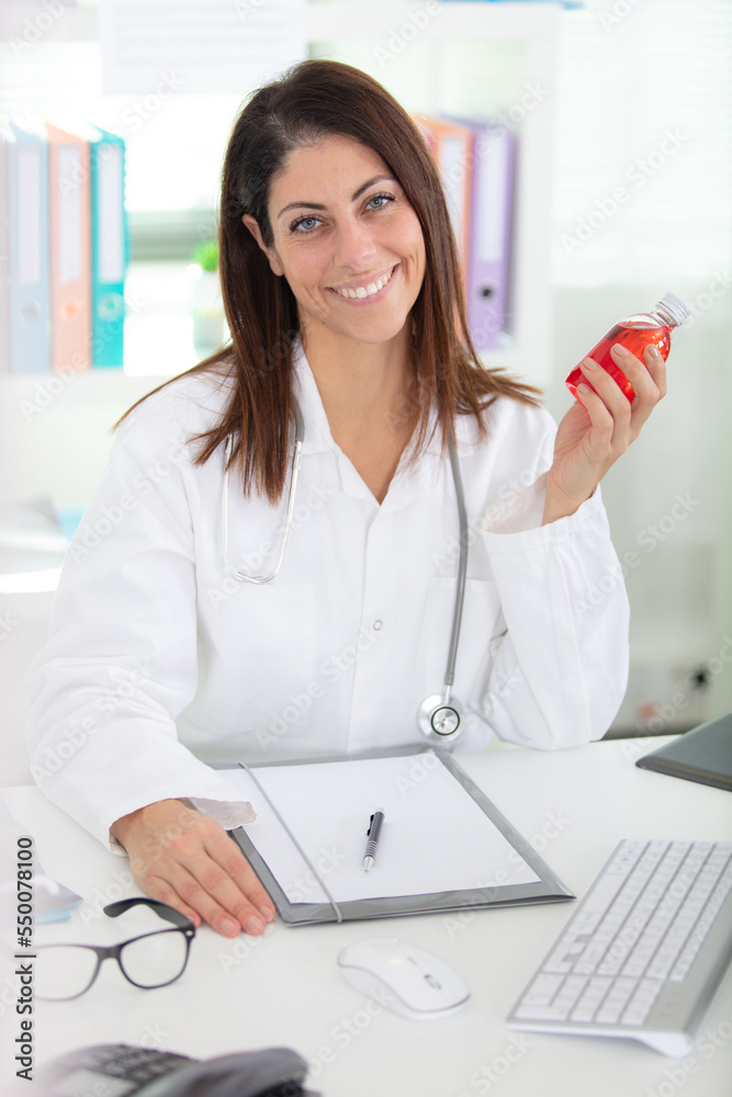 portrait of young smiling female nutritionist in the consultation room portrait of young smiling female nutritionist in the consultation room