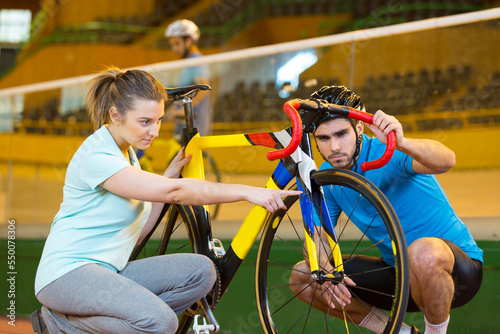 female coach training young man with bike