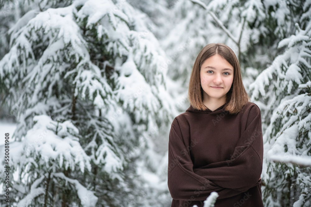 Portrait of a young beautiful fair-haired girl in a winter snowy forest. Portrait of a young beautiful fair-haired girl in a winter snowy forest.