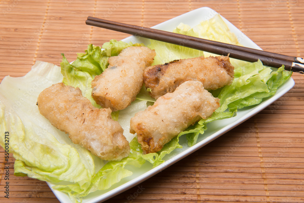 Plate of Vietnamese rolls with chopsticks on endive Plate of Vietnamese rolls with chopsticks on endive