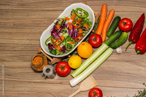 Healthy and fresh salad in bowl with vegetables and fruit