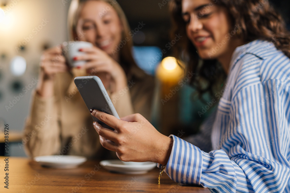 Young woman hold phone at a cafe Young woman hold phone at a cafe