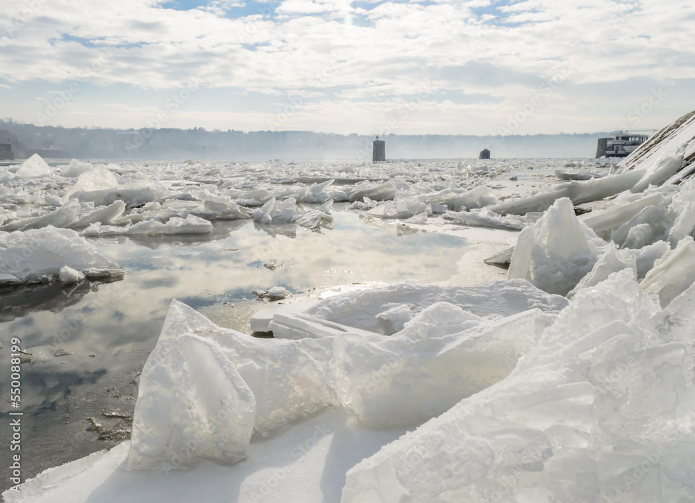 The bank of the Danube river covered with snow. Frozen, snow-covered banks of the Danube River below the Petrovaradin Fortress, Vojvodina, Novi Sad, Petrovaradin, Serbia.