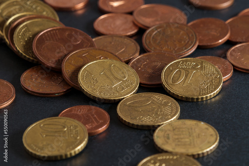Euro coins close up. Small change, petty cash on a black table