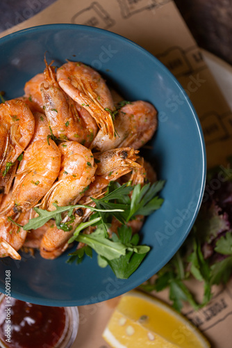 shrimp with lemon and herbs in a blue plate