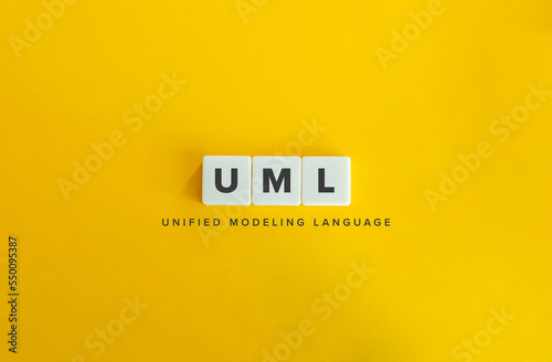 Unified Modeling Language (UML) Banner. Letter Tiles on Yellow Background. Minimal Aesthetics. photo