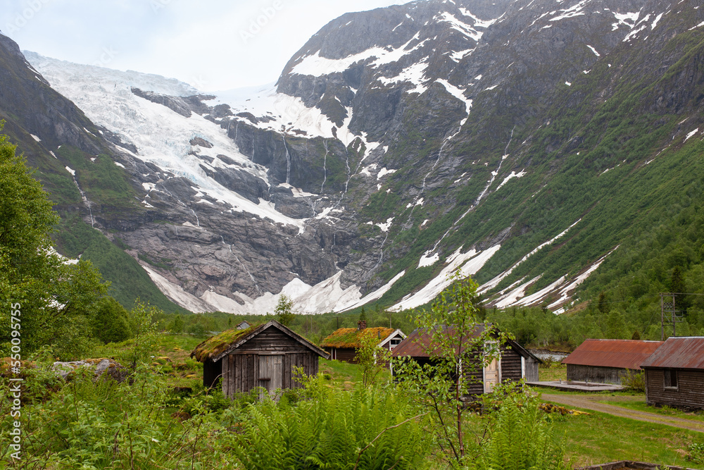 Fjaerland, Norway - June 10 2022: view at Jostedal Glacier with traditional Norway houses