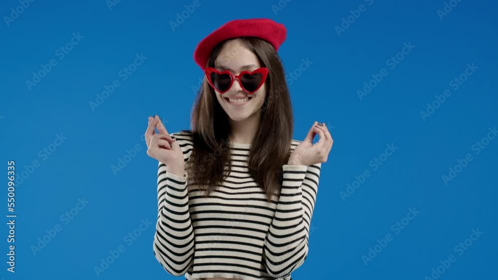 Smiling french woman asking money gesture on blue studio background. Smart fashionable lady smiles slyly, she has idea how to earn. Profitable investments, stock market game, cryptocurrency mining Smiling french woman asking money gesture on blue studio background. Smart fashionable lady smiles slyly, she has idea how to earn. Profitable investments, stock market game, cryptocurrency mining