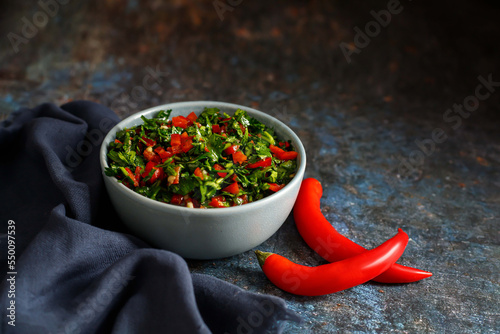 Fresh Chimichurri sauce or Chimmichurri salsa or sauce made of parsley, garlic, oregano, hot pepper, olive oil, vinegar photo