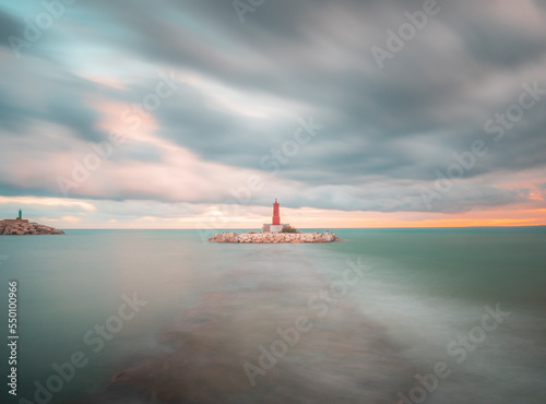 Seascape of Villajoyosa lighthouse in a cloudy day . photo