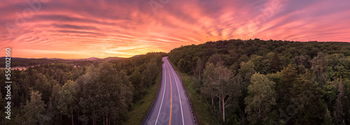 Route 9 road through forest at sunrise, Woodford, Vermont, USA photo