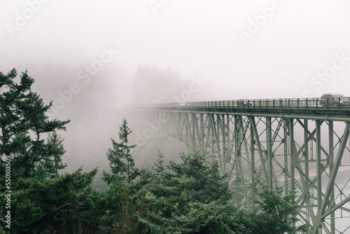 The bridge at Deception Pass over the Puget Sound sits in fog.