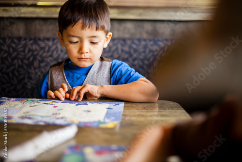 Boy drawing in restaurant photo