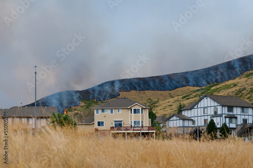 a grass fire near homes. photo