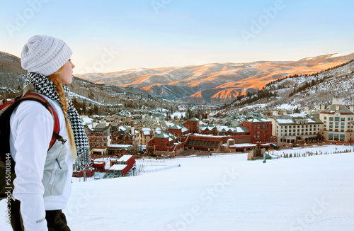 Woman With A Backpack Looks Out Over Beaver Creek Village And Mountains At Dusk photo