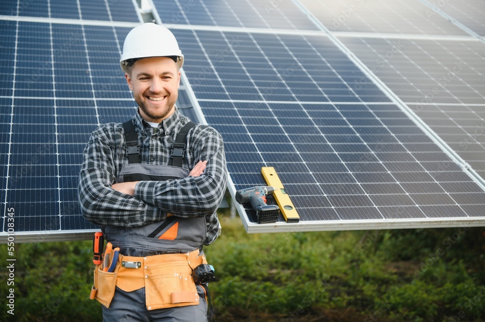 Solar power plant worker checks the condition of the panels Solar power plant worker checks the condition of the panels