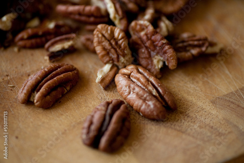 Freshly roasted organic pecans sit on a wooden cutting board in a kitchen in Seattle, Washington.