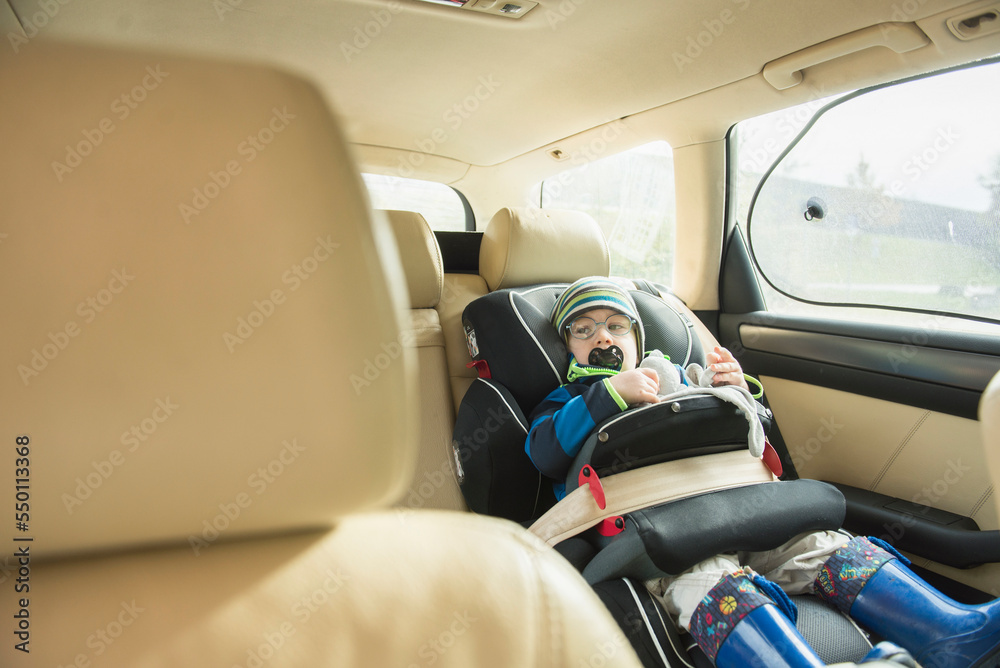Little boy with pacifier in his mouth sitting in car seat Little boy with pacifier in his mouth sitting in car seat