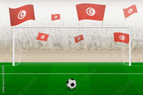 Tunisia football team fans with flags of Tunisia cheering on stadium, penalty kick concept in a soccer match.