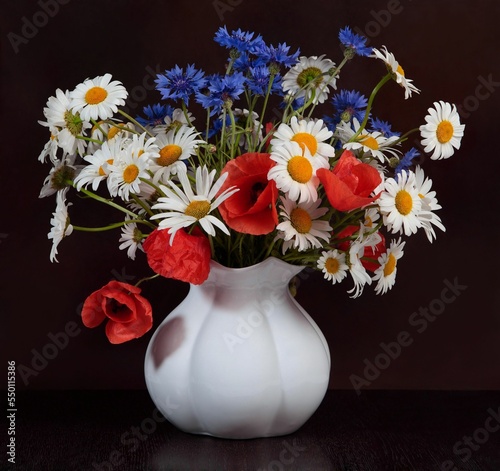 Wild flowers in a vase against a dark background