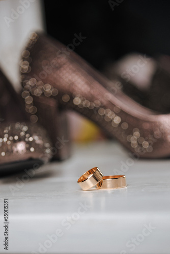 
wedding shoes, a bouquet of flowers and wedding rings