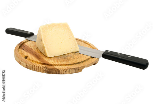 Piece of cheese next to a knife on a wooden board.