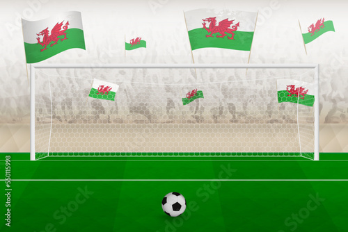 Wales football team fans with flags of Wales cheering on stadium, penalty kick concept in a soccer match.
